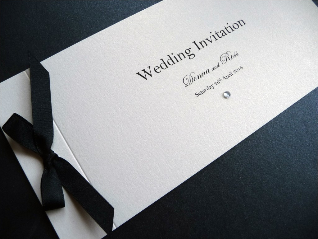 cheque book wedding invitation with a black ribbon bow
